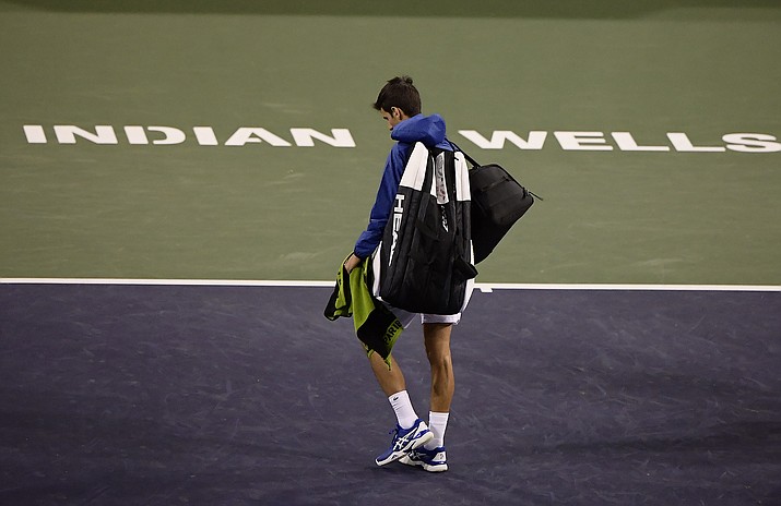 In this Monday, March 11, 2019, file photo, Novak Djokovic, of Serbia, walks off the court during a rain break in his match against Philipp Kohlschreiber, of Germany, at the BNP Paribas Open tennis tournament in Indian Wells, Calif. The BNP Paribas Open tennis tournament, set to begin Wednesday, March 11, 2020, has been postponed after a case of coronavirus was confirmed in the Coachella Valley. (Mark J. Terrill, AP File)