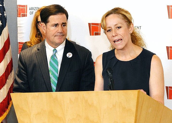 State Health Director Cara Christ details the risks of COVID-19 Monday to Arizona. With her is Gov. Doug Ducey (Capitol Media Services photo by Howard Fischer)