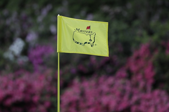 In this April 11, 2019, file photo, the flag on the 13th hole blows in the wind during the first round for the Masters golf tournament in Augusta, Ga. Augusta National decided Friday, March 13, 2020, to postpone the Masters because of the spread of the coronavirus. Club chairman Fred Ridley says he hopes postponing the event puts Augusta National in the best position to host the Masters and its other two events at some later date. Ridley did not say when it would be held.(David J. Phillip, AP File)