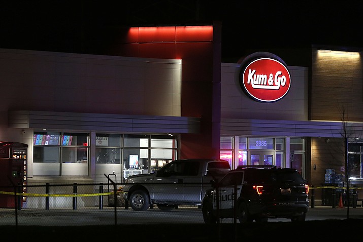 Police respond to the scene of a shooting at a gas station in Springfield, Mo, on Sunday, March 15, 2020. Police Chief Paul Williams said Monday morning, a Springfield police officer, three citizens and the gunman were killed. (Nathan Papes/The Springfield News-Leader via AP)