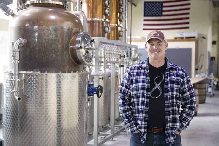 Chad Butters, founder of Eight Oaks Farm Distillery, poses for a photo at their facility in New Tripoli, Pa., Monday, March 16, 2020. Butters, who grew increasingly angry as he saw the skyrocketing price of hand sanitizer, has decided to do something about it: He's temporarily converting his operation into a production line for the suddenly hard-to-find, gooey, alcohol-based disinfectant. (AP Photo/Matt Rourke)
