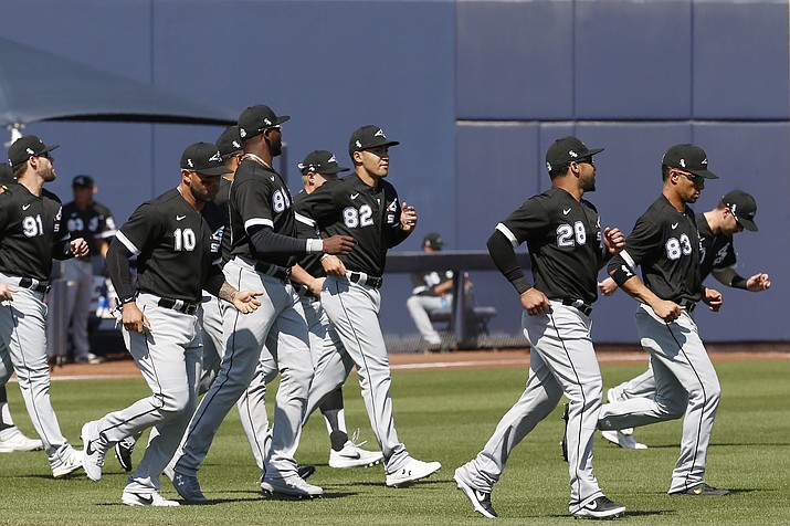 Chicago White Sox players warm up before a spring training game against the Milwaukee Brewers, Wednesday, March 4, 2020, in Phoenix. (Sue Ogrocki/AP)