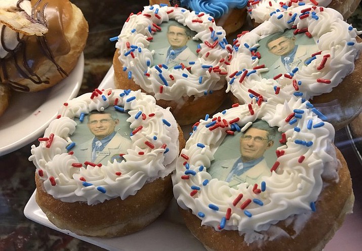 In this Wednesday, March 25, 2020 photo, donuts bearing the likeness of Dr. Anthony Fauci, director of the National Institute of Allergy and Infectious Diseases, rest on a plate at Donuts Delite in Rochester, N.Y. Donuts Delite began making donuts featuring Fauci's face earlier in the week. (Shawn Dowd/Democrat &amp; Chronicle via AP)