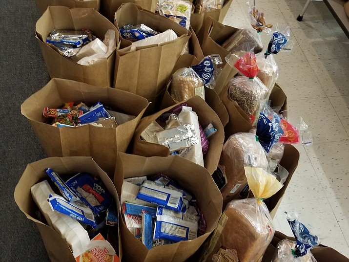 Brown paper bags filled with food before volunteers of the Chino Valley Hungry Kids Project delivered them to families around the community on Thursday, March 26, 2020, at Heritage Middle School in Chino Valley. (Cindy Daniels/Courtesy)