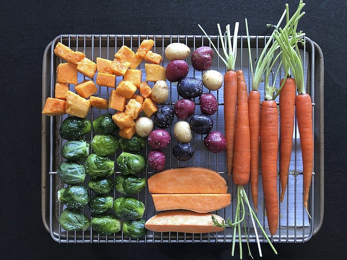 This March 2, 2020 image shows various vegetables placed on a rack prior to roasting in Amagansett, N.Y. The key to roasting and grilling is having the natural sugars in the vegetables browned and caramelized, resulting in both great texture and flavor. (Elizabeth Karmel via AP)