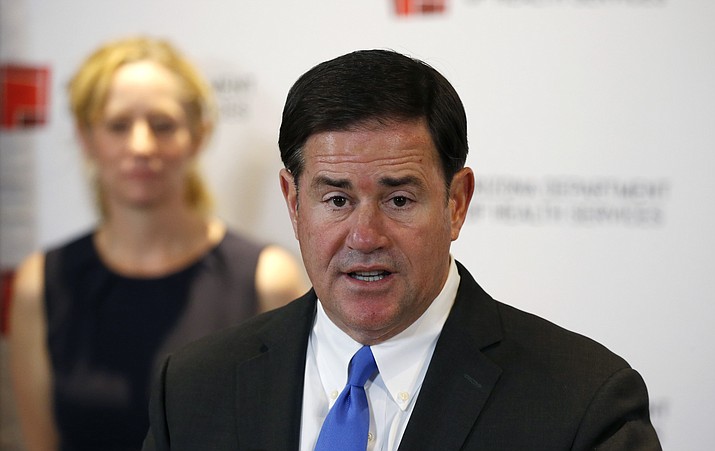 In this file image, Arizona Gov. Doug Ducey and health director Cara Christ provide details on the spread of COVID-19. (Howard Fischer/Capitol Media Services)