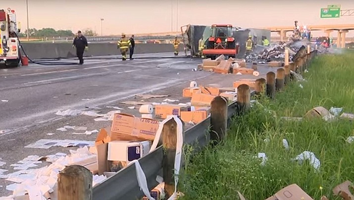 A tractor-trailer hauling toilet paper crashed and caught fire near Dallas early Wednesday, spilling the hot commodity all over an interstate. (Associated Press, YouTube capture)