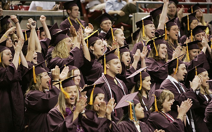 Arizona State University students celebrate in this spring 2006 graduation photo. ASU President Michael Crow on Thursday announced in-person May commencement ceremonies will be canceled because of the novel coronavirus pandemic. Graduates will be celebrated in a virtual ceremony. (Tom Story/ASU, via Cronkite)