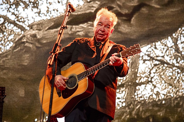 This June 15, 2019 file photo shows John Prine performing at the Bonnaroo Music and Arts Festival in Manchester, Tenn. Prine died Tuesday, April 7, 2020, from complications of the coronavirus. He was 73. (Photo by Amy Harris/Invision/AP, File)