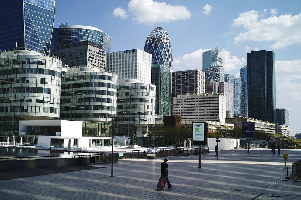A man walks on the square of La Defense business district during nationwide confinement measures to counter the Covid-19, in Paris, Thursday, April 9, 2020. The new coronavirus causes mild or moderate symptoms for most people, but for some, especially older adults and people with existing health problems, it can cause more severe illness or death. (AP Photo/Thibault Camus)
