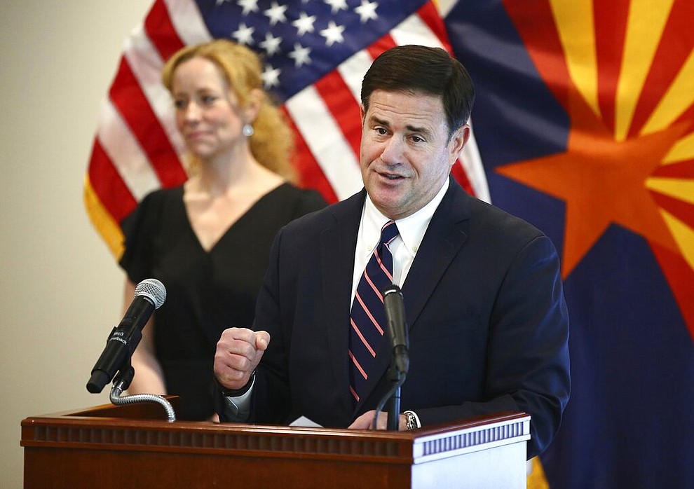 Arizona Gov. Doug Ducey and Arizona Department of Health Services Director Dr. Cara Christ give an update on the COVID-19 pandemic response Tuesday, April 14, 2020 during a news conference at the Arizona Commerce Authority in Phoenix. (Rob Schumacher/The Arizona Republic via AP, Pool)