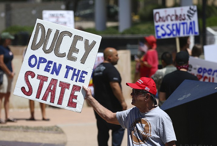 Protesters rally at the state Capitol to ‘re-open’ Arizona against the governor’s stay-at-home order due to the coronavirus Monday, April 20, 2020, in Phoenix. (Ross D. Franklin/AP)