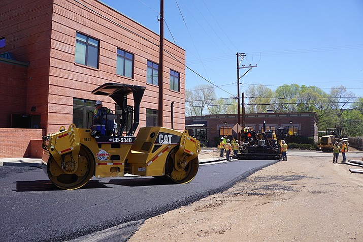 Workers apply pavement on April 24, to two streets under construction as a part of the Goodwin, McCormick, Beach, Summit improvement project. (Cindy Barks/Courier)