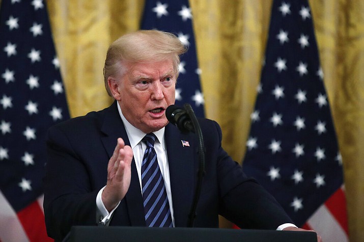 President Donald Trump answers questions from reporters during a event about protecting seniors, in the East Room of the White House, Thursday, April 30, 2020, in Washington. (AP Photo/Alex Brandon)