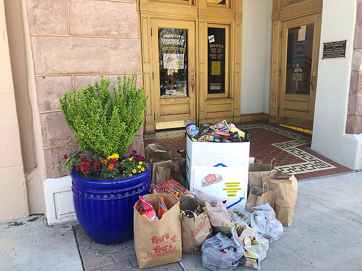 Piles of food, donated as part of the “Two Grand for Groceries” fundraiser and food drive, sit outside the Prescott Chamber of Commerce in downtown Prescott. The effort, which included area chambers and KPPV and associated radio stations, collected $16,010. (Courtesy)