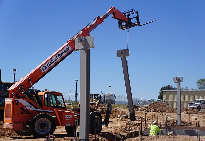 On Tuesday morning, May 5, crews work to install one of 30 steel columns at the site of the new passenger terminal at the Prescott Regional Airport. The column installation marked the first vertical work on the project that has been underway for about four or five months. (Cindy Barks/Courier)