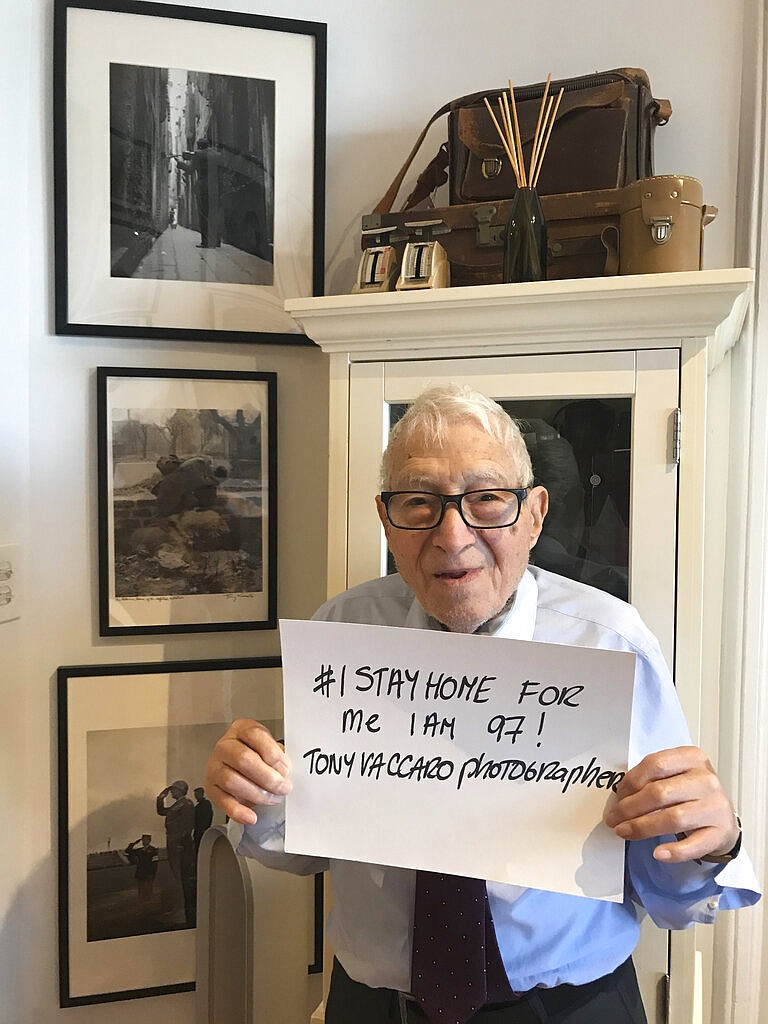 In this photo taken on March 21, 2020 Tony Vaccaro poses for a photo at his studio in Long Island City, in the Queens borough of New York. Amid the bleakness of the pandemic, some veterans still know how to win that 2020 war too — spurious comparison or not. Vaccaro, 97, was thrown into WWII with the 83rd Infantry division which fought, like Charles Shay, in Normandy, and then came to Schmetz's doorstep for the Battle of the Bulge. On top of his military gear, he also carried a camera, and became a fashion and celebrity photographer after the war. COVID-19 caught up with him last month. Like everything bad life threw at him, he shook it off, attributing his survival to plain "fortune." (Photo courtesy Maria Vaccaro via AP)