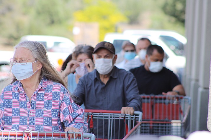 Customers waiting to get into the Prescott Costco on Saturday, May 9, 2020, all wear face masks — a new requirement by the warehouse retailer this past week. Mayors from the tri-city area told The Daily Courier they do not plan to institute similar requirements as area businesses and government offices gradually reopen. (Brian Haddad/For the Courier)
