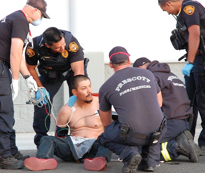 First responders treat Alfredo Saldivar, 28, who was captured by police Wednesday night, May 13, 2020, after he fled from officers at speeds reaching 120 mph and striking cars. (Tim Wiederaenders/Courier)