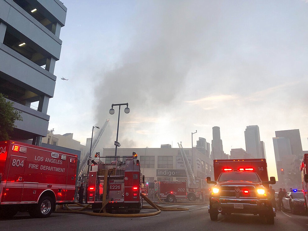 Firefighters respond to an explosion in downtown Los Angeles that has injured multiple firefighters and caused a fire that spread to several buildings, Saturday, May 16, 2020, in Los Angeles. (AP Photo/Stefanie Dazio)