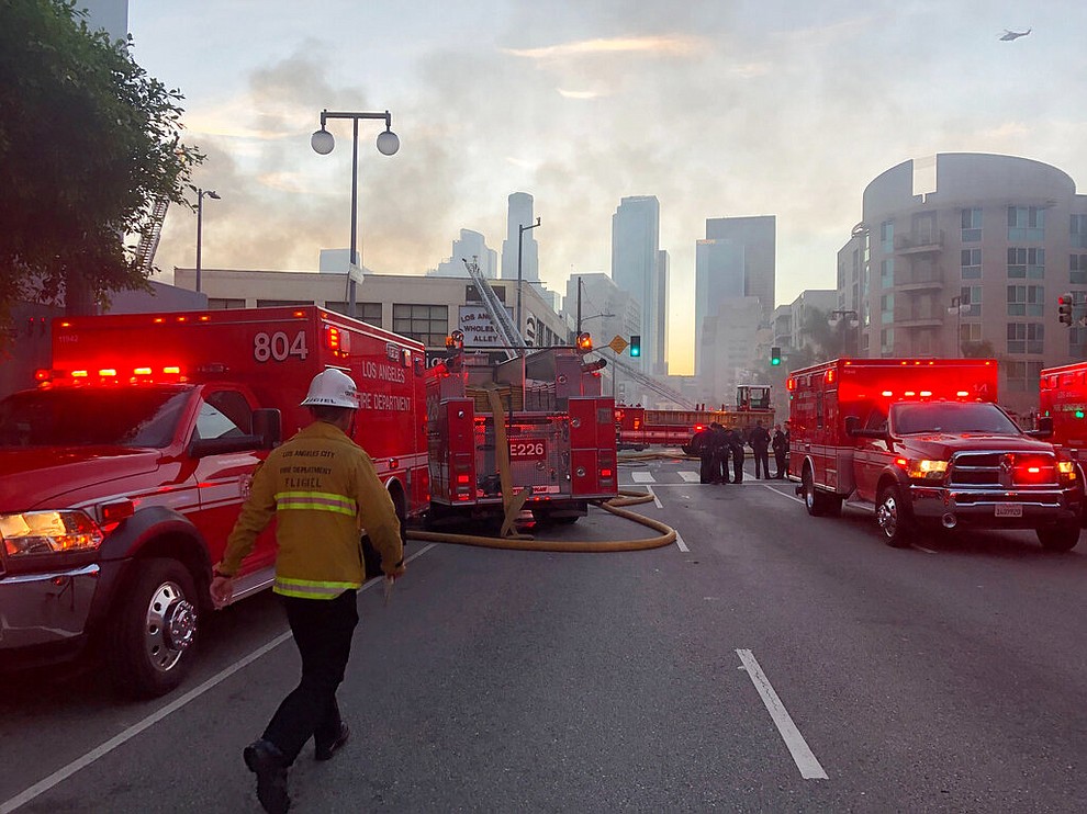 Firefighters respond to an explosion in downtown Los Angeles that has injured multiple firefighters and caused a fire that spread to several buildings, Saturday, May 16, 2020, in Los Angeles. (AP Photo/Stefanie Dazio)