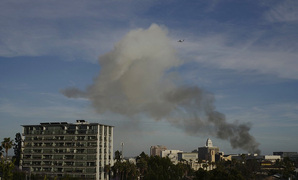 Smoke rises from an explosion at a structure fire Saturday, May 16, 2020, in Los Angeles. (AP Photo/Damian Dovarganes)