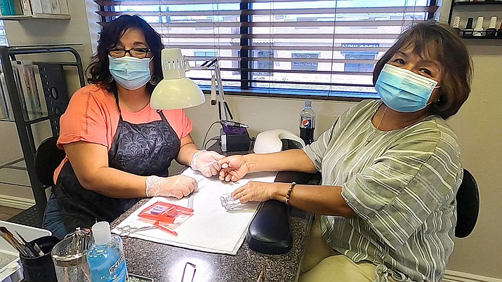 Copper Basin Salon & Spa Owner Alma Fonte, left, gives her mother Connie Rodelo, a retired nurse, a much needed manicure on Friday, May 15, 2020. (Jesse Bertel/Courier)