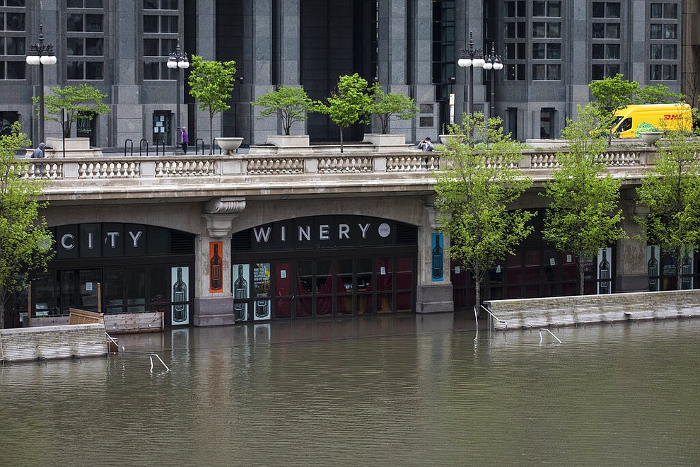 The Chicago River overflowed its banks and flooded the Riverwalk after overnight showers and thunderstorms across the city Monday, May 18, 2020 in Chicago. (Ashlee Rezin Garcia/Chicago Sun-Times via AP)