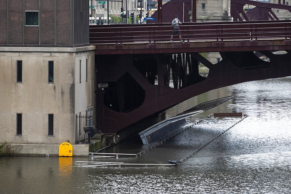 The Chicago River overflowed its banks and flooded the Riverwalk after overnight showers and thunderstorms across the city, Monday, May 18, 2020 in Chicago. (Ashlee Rezin Garcia/Chicago Sun-Times via AP)