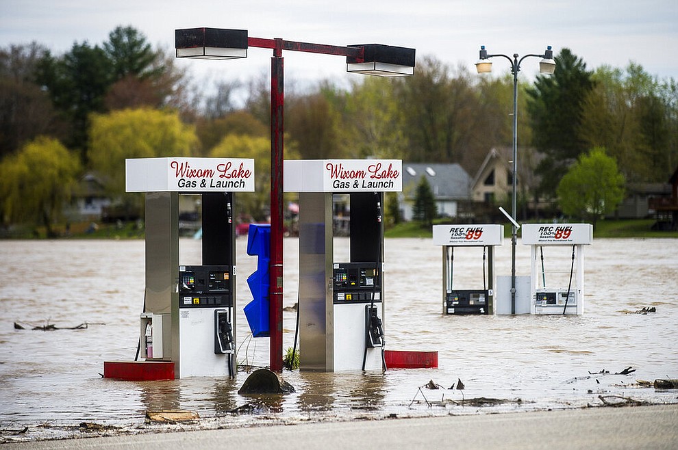 Floodwater surrounds gas pumps at Wixom Lake Gas & Launch Tuesday, May 19, 2020 along the Tittabawassee River in Beaverton, Mich. (Katy Kildee/Midland Daily News via AP)
