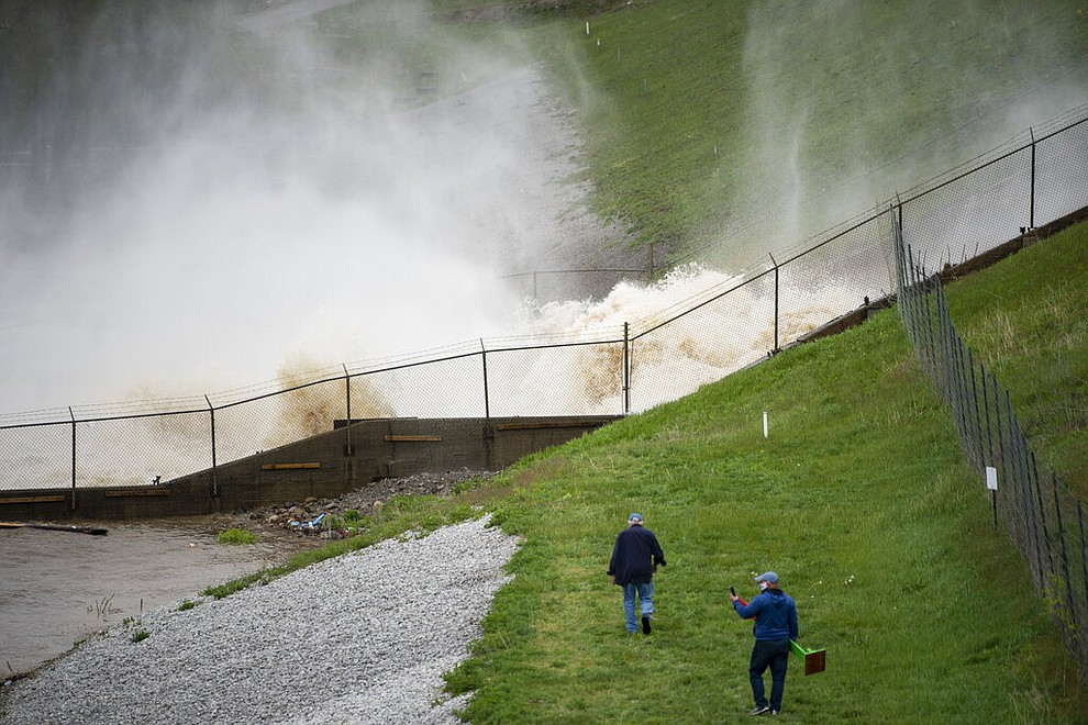 This photo shows a view of a dam on Wixom Lake in Edenville, Mich., Tuesday, May 19, 2020. People living along two mid-Michigan lakes and parts of a river have been evacuated following several days of heavy rain that produced flooding and put pressure on dams in the area. (Kaytie Boomer/The Bay City Times via AP)