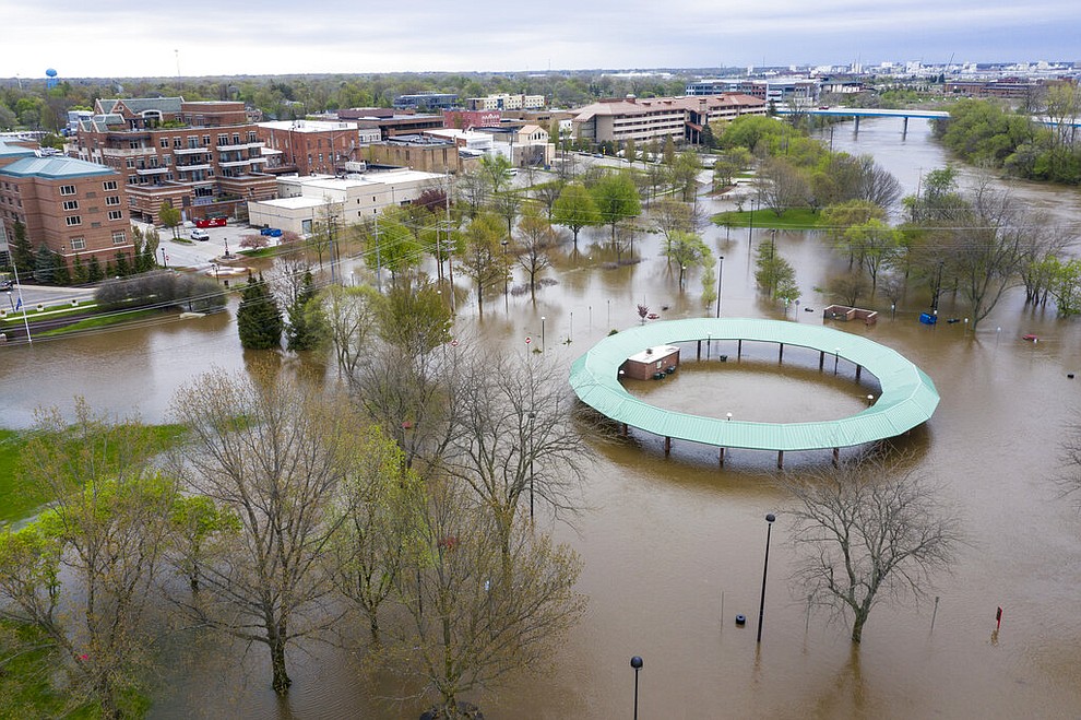 Water floods the Midland Area Farmers Market and the bridge along the Tittabawassee River in Midland, Mich. on Tuesday, May 19, 2020. (Kaytie Boomer/MLive.com/The Bay City Times via AP)