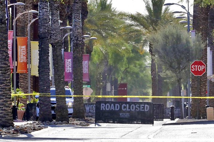 The Westgate retail district is closed off Thursday, May 21, 2020, in Glendale, Ariz. Police say one person is in critical condition and two others were injured in a shooting Wednesday evening near the shopping and entertainment district west of Phoenix. A Glendale police spokeswoman said Wednesday that the suspect was taken into custody safely. (AP Photo/Matt York)