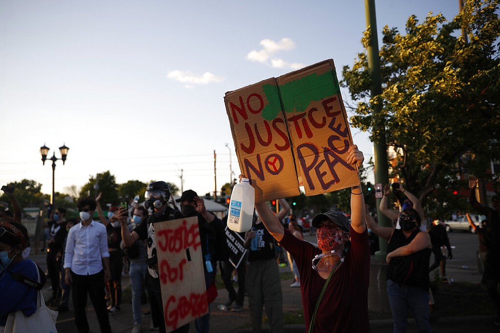 Demonstrators gather Thursday, May 28, 2020, in St. Paul, Minn. Protests over the death of George Floyd, the black man who died in police custody broke out in Minneapolis for a third straight night. (AP Photo/John Minchillo)