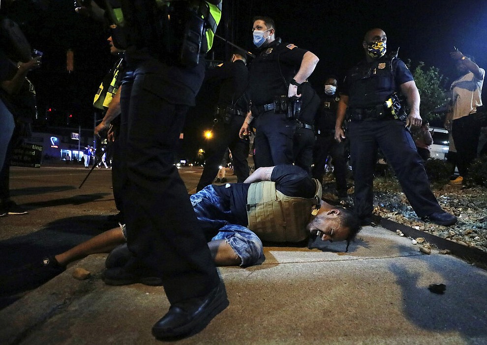 A protestor winces in pain after being pepper sprayed by Memphis police during a protest over the death of George Floyd, Thursday, May 28, 2020, in Memphis, Tenn. (Patrick Lantrip/Daily Memphian via AP)