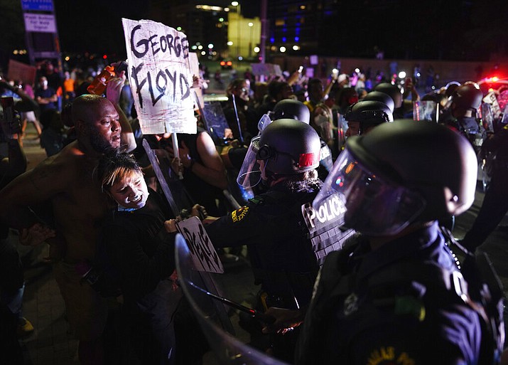 Protesters clash with Dallas police at Griffin and Young on Friday, May 29, 2020, in Dallas. The protest was organized by Next Generation Action Network in response to the in-custody death of George Floyd in Minneapolis. (Smiley N. Pool/The Dallas Morning News via AP)