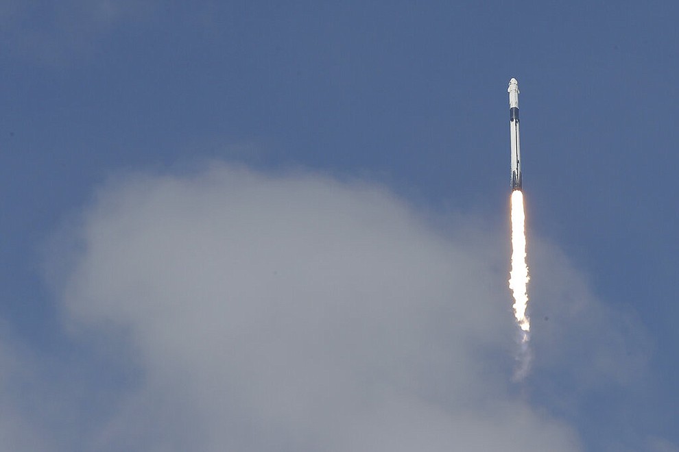 The SpaceX Falcon 9 and the Crew Dragon capsule, with NASA astronauts Bob Behnken and Doug Hurley onboard, lifts off Saturday, May 30, 2020, at the Kennedy Space Center in Cape Canaveral, Fla. (AP Photo/Chris O'Meara)