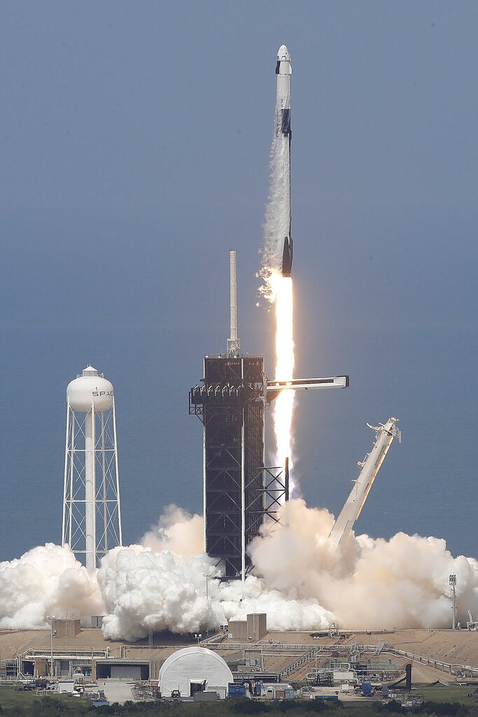 The SpaceX Falcon 9 and the Crew Dragon capsule, with NASA astronauts Bob Behnken and Doug Hurley onboard, lifts off Saturday, May 30, 2020, at the Kennedy Space Center in Cape Canaveral, Fla. (AP Photo/Chris O'Meara)