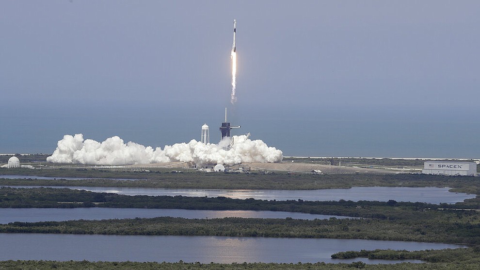 The SpaceX Falcon 9 and the Crew Dragon capsule, with NASA astronauts Bob Behnken and Doug Hurley onboard, lifts off Saturday, May 30, 2020, at the Kennedy Space Center in Cape Canaveral, Fla. (AP Photo/Chris O'Meara)