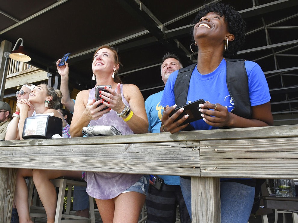 Spectators at Shiloh's Steak & Seafood restaurant in Titusville, Fla. watching the launch of the SpaceX rocket, Saturday, May 30, 2020. (Tim Shortt/Florida Today via AP)
