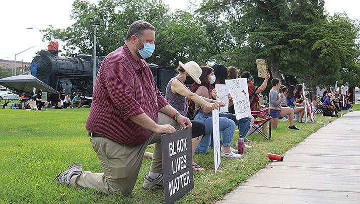 Several dozen protesters had turned out by 8 a.m. Tuesday, June 2 at Locomotive Park, 310 W. Beale St. (Photo by Travis Rains/Kingman Miner)