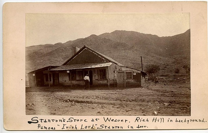 In the only known verified photograph of Charles P. Stanton, the notorious late 1800s-era businessman stands in front of his store, with the Yarnell-area Rich Hill in the background. (Sharlot Hall Museum/Courtesy)