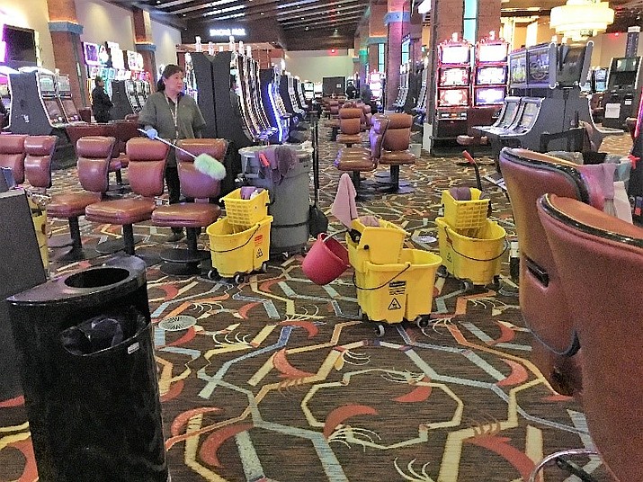 Navajo Gaming Team members completing additional cleaning and removal of chairs at Northern Edge Navajo Casino. (Photo courtesy of Neil Johns, NNGE)