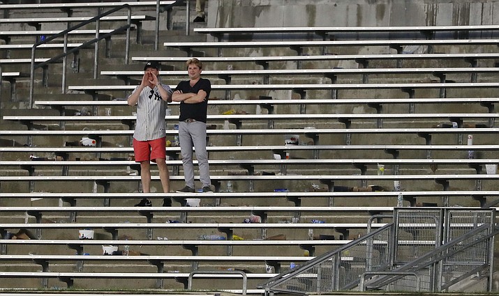 In this Aug. 2, 2017, file photo, baseball fans cheer from the right field bleacher seats after a rain delay in a baseball game between the New York Yankees and the Detroit Tigers in New York. The crippling grip the coronavirus pandemic has had on the sports world has forced universities, leagues and franchises to evaluate how they might someday welcome back fans. (Julie Jacobson/AP, file)