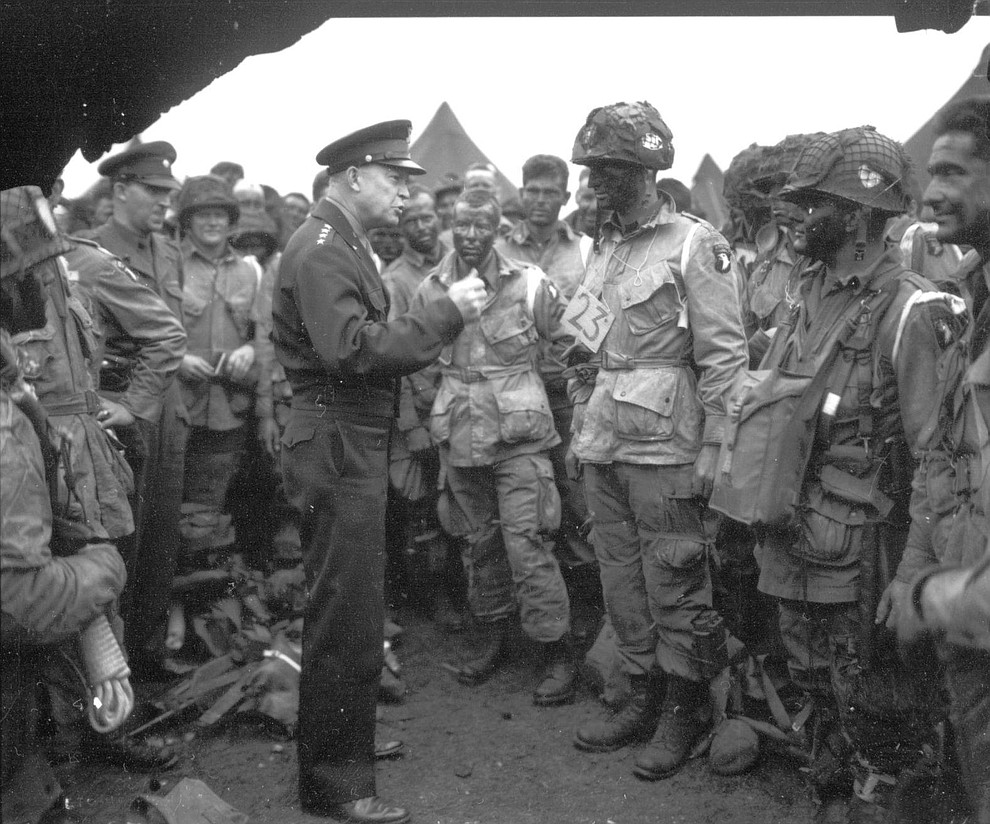 Supreme Commander Dwight Eisenhower gives the order of the day "Full victory - Nothing else" to paratroopers of the 101st Airborne Division at the Royal Air Force base in Greenham Common, England, three hours before the men board their planes to participate in the first assault wave of the invasion of the continent of Europe, June 5, 1944. (AP Photo)