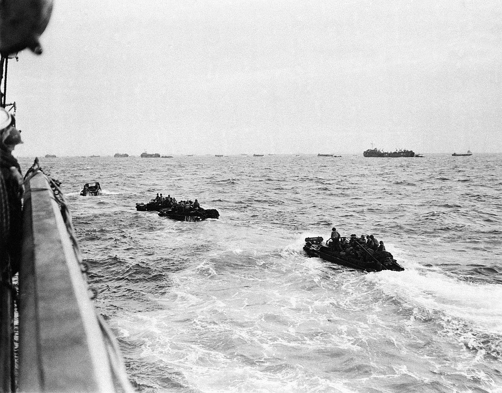 Bouncing about on the rough waters of the Channel, these landing craft loaded with assault troops head for the shore of the French coast early in the dawn of D-Day, June 6, 1944. In the surprise invasion attack, the allies suffered a minimum loss and have succeeded in cutting a 29-mile wedge in the Cherbourg Penninsular. (AP Photo)..