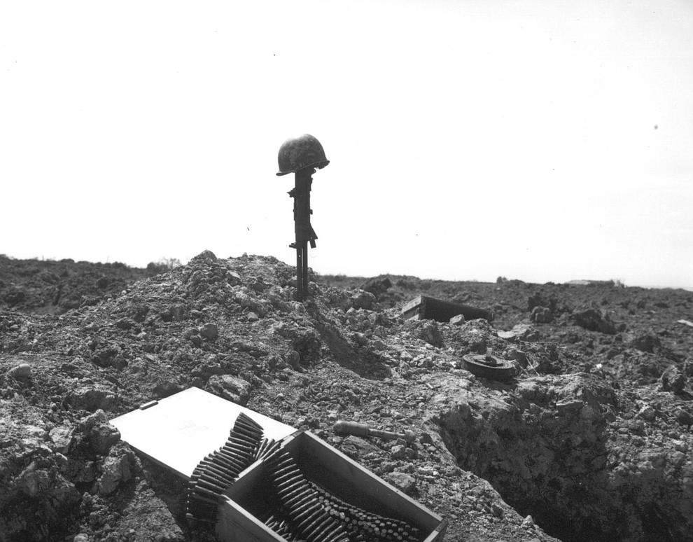 A tribute to an unknown American soldier, who lost his life fighting in the landing operations of the Allied Forces, marks the sand of Normandy's shore, in June 1944. (AP Photo)..