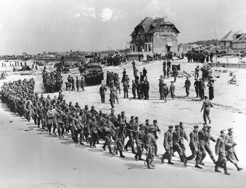 German prisoners of war, captured during the Allied Normandy invasion, are marched to the ships that bring them into captivity in England, in June 1944, at Bernieres-sur-mer, France. (AP Photo)..