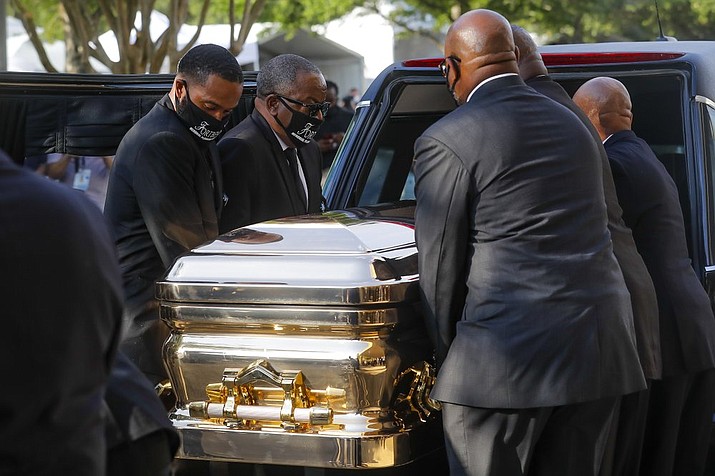 George Floyd's casket is loaded into a hearse after being brought out of Fountain of Praise church following a public visitation Monday, June 8, 2020, in Houston. Floyd died May 25 after being restrained by Minneapolis police. (Godofredo A. Vásquez/Houston Chronicle via AP, Pool)