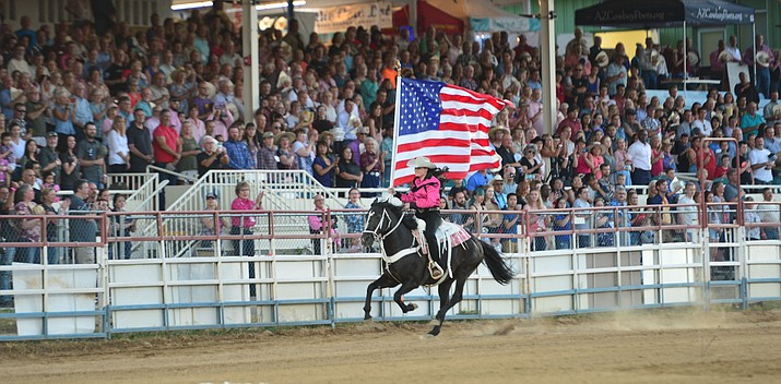 The American flag is presented during the second performance of the Prescott Frontier Days Rodeo on July 2, 2019.  (Les Stukenberg/Courier, file)